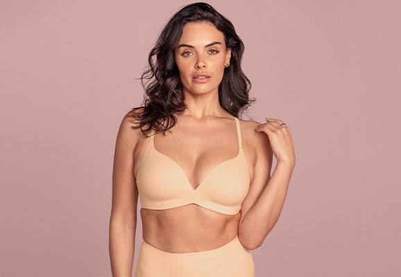 Model wearing a neutral bra with matching shaping briefs