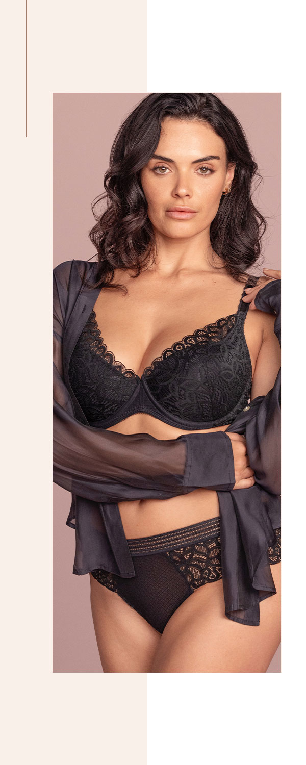 Model wearing a black bra with all over lace cups and matching briefs